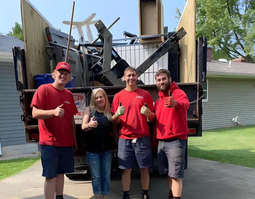 Truck team standing behind our junk truck with an extremely satisfied customer