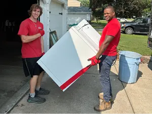 Team holding washing machine