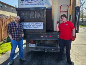 Truck team member and customer standing by truck