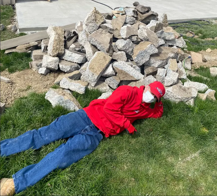 Employee showing scale of concrete pile