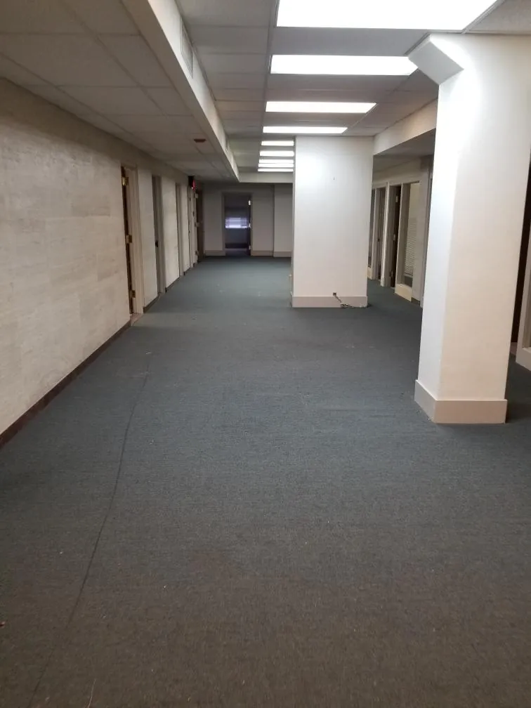 The same office hallway completely empty after the Express Junk Removal crew finished